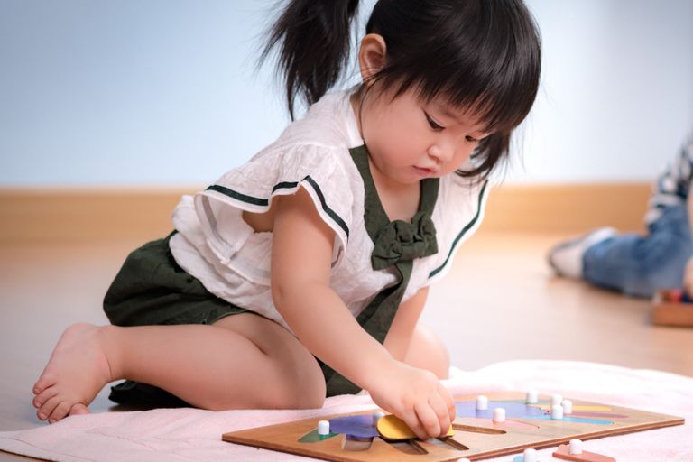 Two boys reading and writing, working together