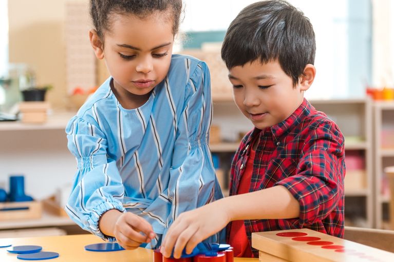Two boys reading and writing, working together